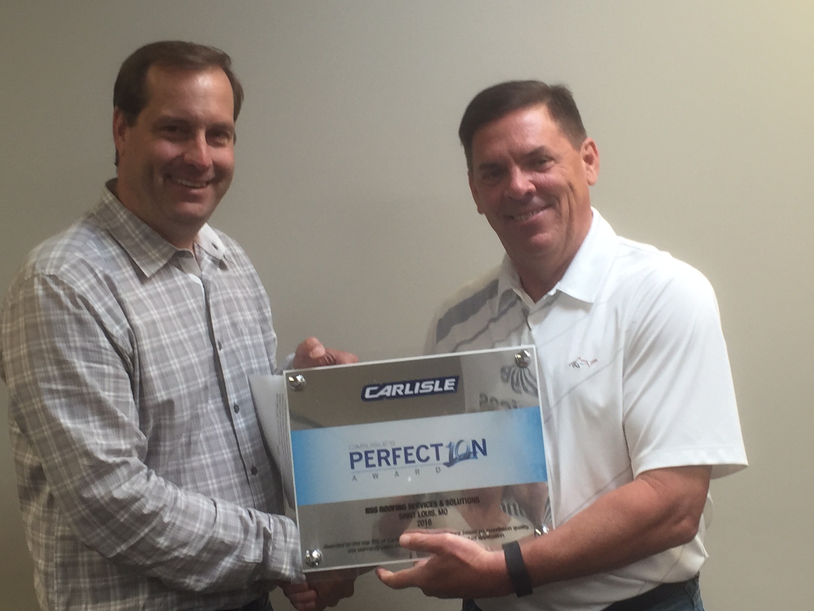 Joe Lauberth, with Roofing Services & Solutions (RSS) of St. Louis, Missouri received Carlisle's Perfection Award from Greg Luna, President of Luna and Associates.